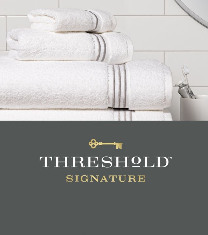 Threshold Signature white with gray stripe towels on bathroom counter