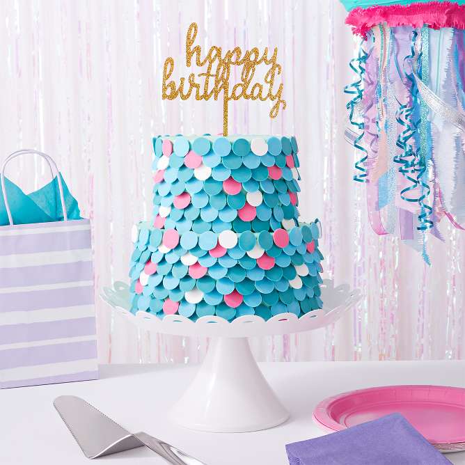 Mermaid scale cake
Use one round 8-inch cake tin and one round 6-inch cake tin with your favorite cake mix. For the frosting, mix buttercream with the color of your choice (rec: sea-foam green or teal), and add frosting between each layer of cake. For the scales, use chocolate candy melts of different colors (rec: teal, white & pink). Start at the bottom of the cake and work your way up, layering them on top of each other.

Tip: Place the rounder side of the candy melts onto the frosting (flat side facing out).