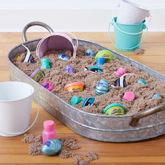 Treasure dig activity
Fill a large container with sand and treasures of your choosing. Hand the kids pails and shovels and they’ll be on their way! Suggested ideas for containers: under-the-bed storage bin, plastic pool, large bucket–you get it. 

Tip: Instead of shovels, kids can dig for treasure with strainers or colanders.