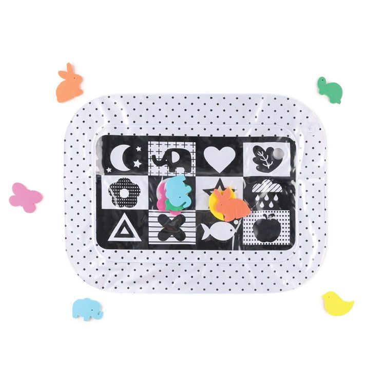 Rectangular playmat with black and white patterns, surrounded by colorful animal-shaped pieces.