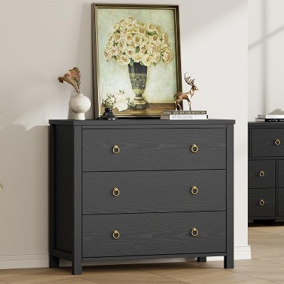 Three-drawer dresser with top decor and framed artwork