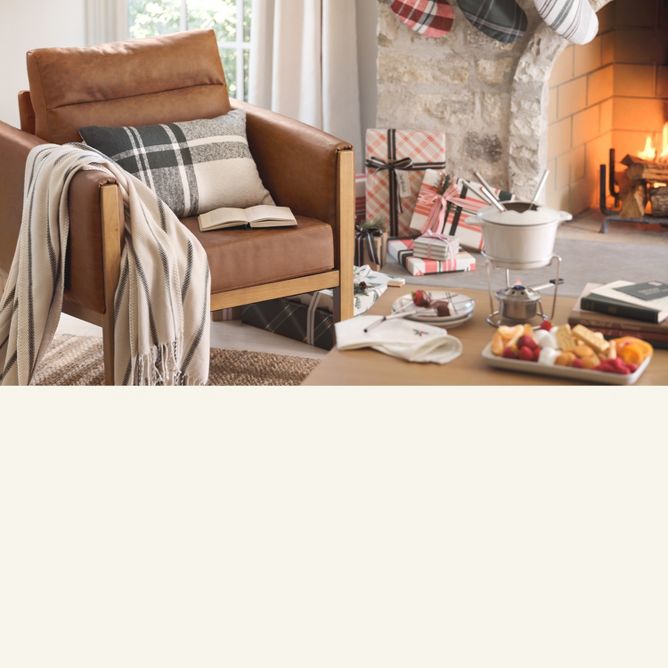 Left: Arm chair with plaid blanket and pillow next to decorated fireplace make a cozy corner. Right: Holiday faux greens and candles creative festive charm.