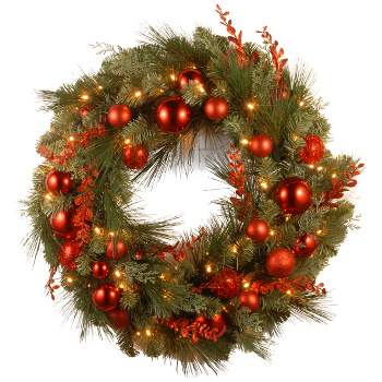 National Tree Company 24" Pre-Lit Artificial Christmas Wreath, Evergreen, White Lights, with Ball Ornaments, Red Sprigs