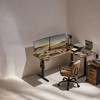 Shaped Electric Standing Desk, 63 x 47.2 inches. A height - adjustable corner desk with power outlets and 2 memory buttons. - 3 of 4