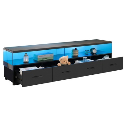 Open view of a black media console showing drawers and storage