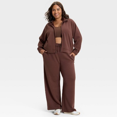 Brown colored jacket with a front zipper and long sleeves.