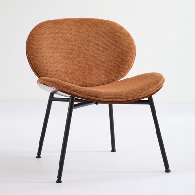 Side view of orange-brown shell chair with black legs