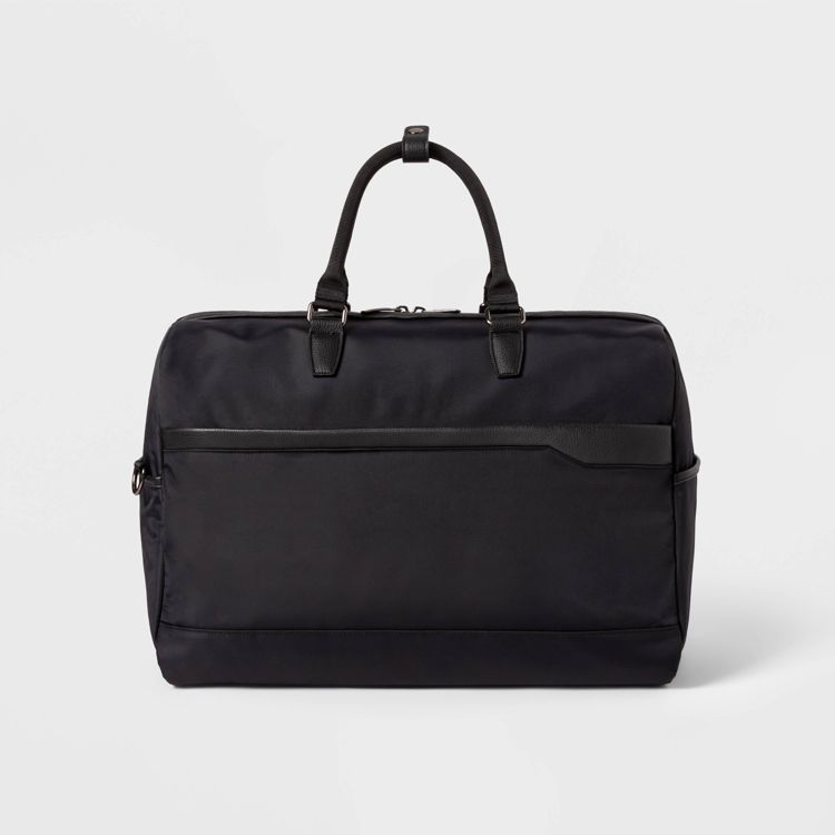 A black colored duffel bag with two handles and a front pocket.