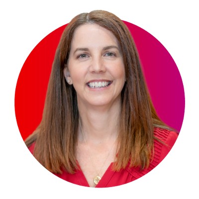 Target Vice President Meredith Jordan, a woman with light skin and long brown hair, pictured smiling against a red background