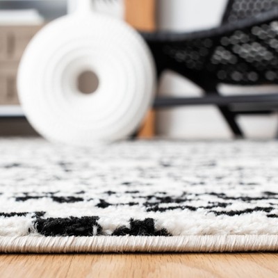 Ivory and Black Geometric Synthetic 9' x 12' Area Rug