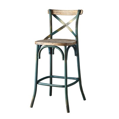 Antique teal bar stool with wooden seat and cross-back, angled view