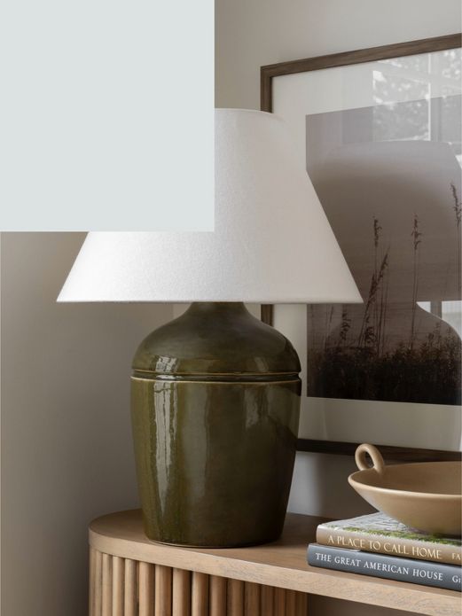 Green ceramic lamp on entry table