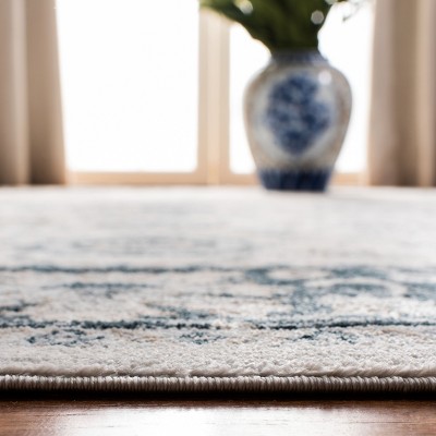 Isabella Cream and Navy 4' x 6' Synthetic Oriental Area Rug