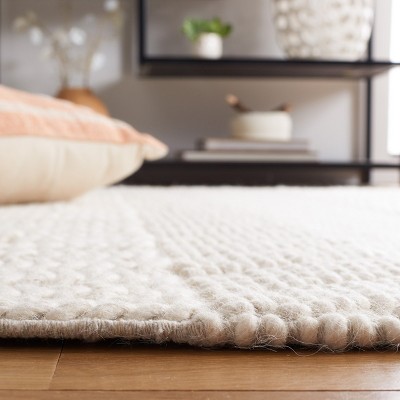 Ivory Handmade Wool Tufted 6' x 9' Area Rug