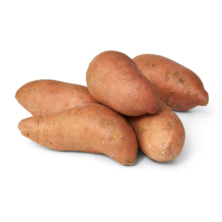 A group of five brownish-orange colored sweet potatoes arranged on a white surface.
