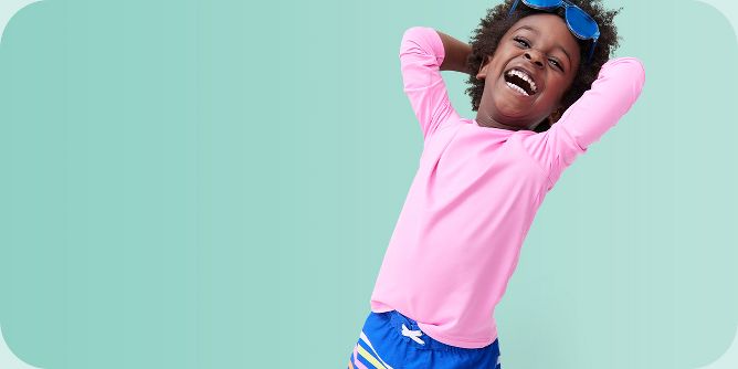 Kids and sport. Side view of a happy little girl smiling at camera