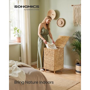 25-Gallon Handwoven Laundry Hamper with Lid and Washable Liner, Natural Water Hyacinth Basket with Wooden Feet, Steel Frame - 1 of 4