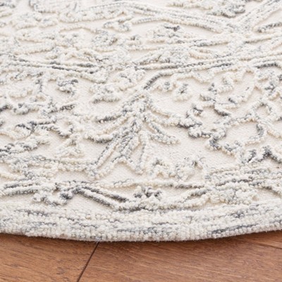 Handmade Ivory and Charcoal Round Tufted Wool Area Rug