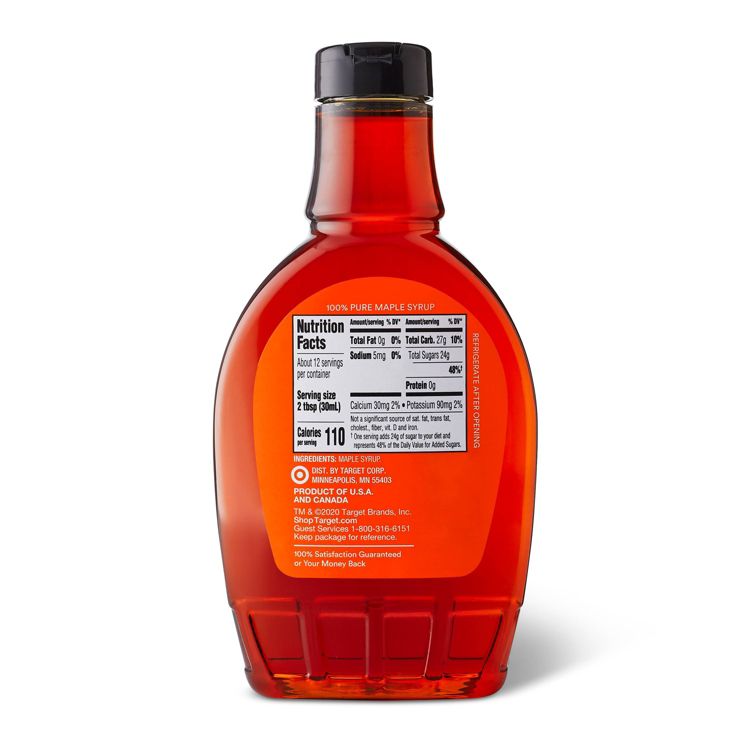 A bottle of 100% pure maple syrup with a nutrition facts label showing 110 calories per serving and ingredients listed as maple syrup.
