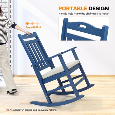 Person using blue wooden rocking chair with backrest and handle