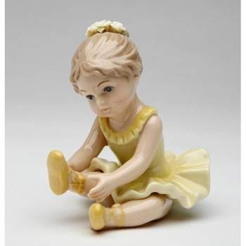 Kevins Gift Shoppe Ceramic Ballerina Gril in Yellow Stretching Her Leg Figurine