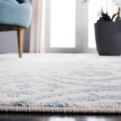 Ivory and Blue Floral Synthetic 6' x 9' Area Rug