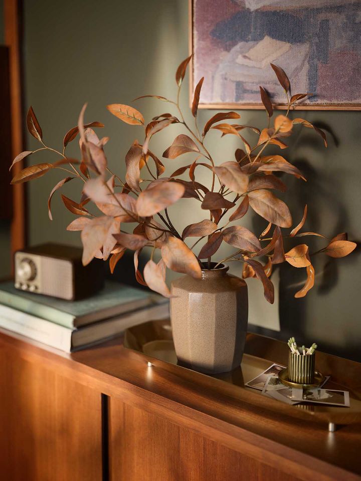 Faux autumn greenery in vase