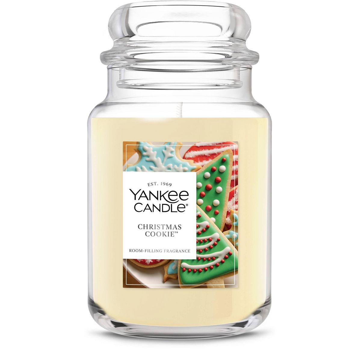 A white candle in a lidded glass jar