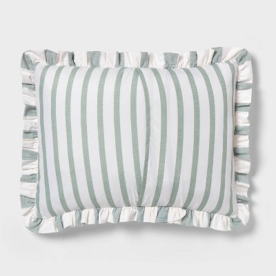 A pillow with green and white vertical stripes and ruffled edges.