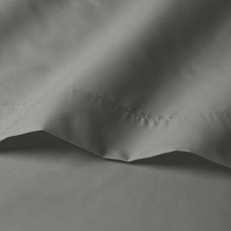 A close-up of gray colored sheet fabric with visible stitching detail.