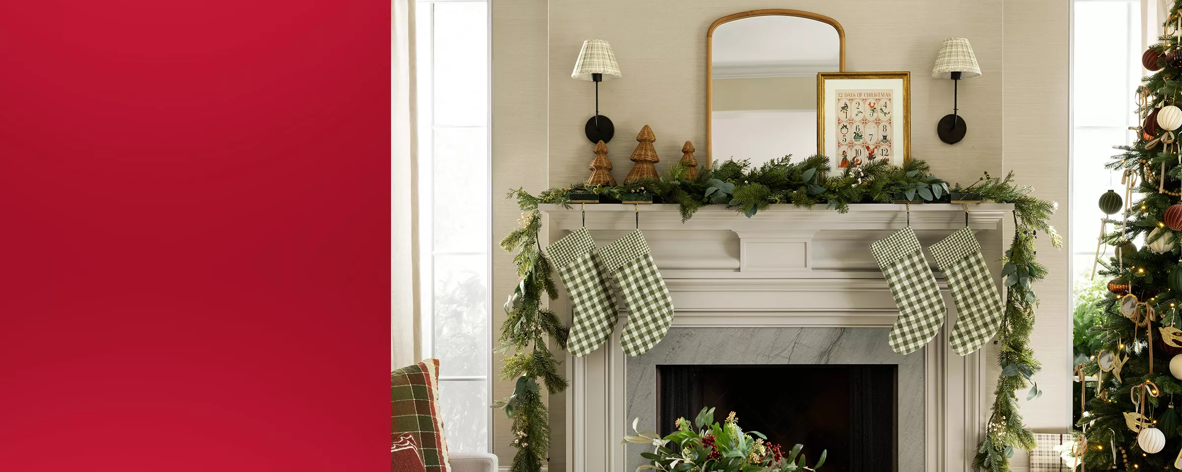 Mantel styled with plaid stockings, wicker decor trees and Christmas wall art