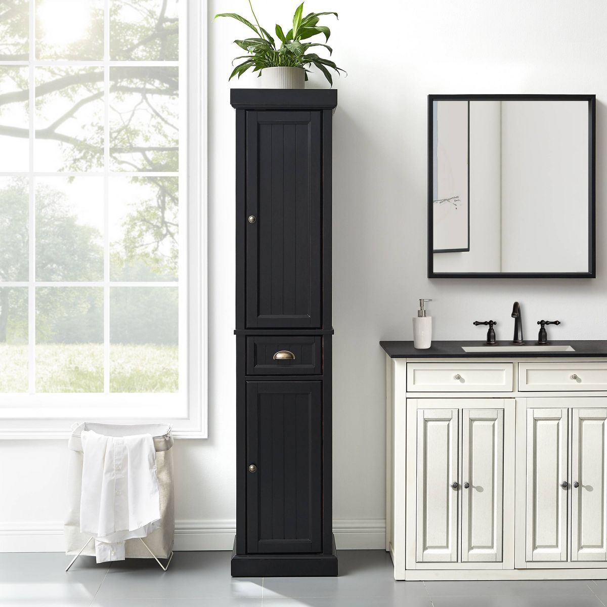 Tall black storage cabinet beside bathroom vanity