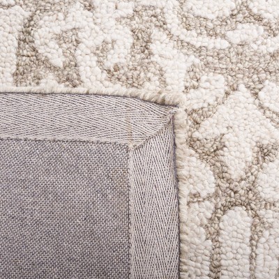 Handmade Ivory Abstract Tufted Wool Round Rug