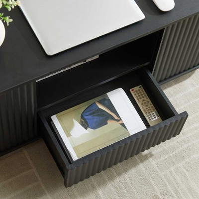 Open drawer showing storage with magazine and remote on the pull-out drawer
