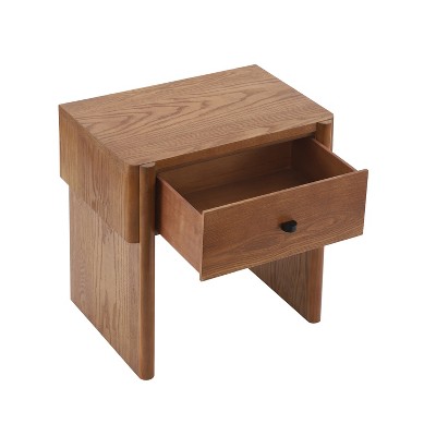 A wooden nightstand with a single open drawer and a black knob.