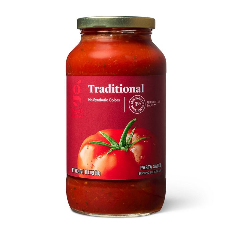 A jar of traditional pasta sauce with a red label featuring a tomato image and text stating "No Synthetic Colors" and "1 ½ Servings of Vegetables Per Half Cup Sauce," with a net weight of 24 oz (1 lb 8 oz) 680g.