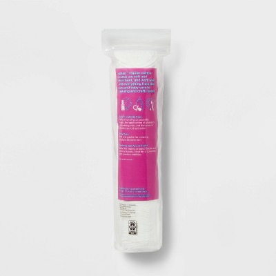 A cylindrical package of cotton pads with a pink colored label displaying usage instructions and icons.