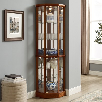 Corner display cabinet with ceramic vases and glassware