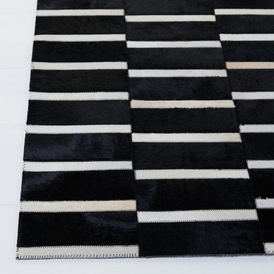 Handmade Black and Beige Geometric Cowhide Area Rug
