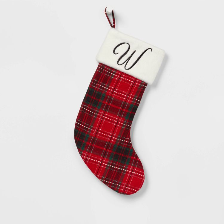 Red and green plaid colored Christmas stocking with a white cuff featuring the letter "W."