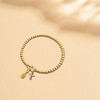Free bird Cross Birthstone Bracelet | Dainty 14K Gold Plated Cross Charm Bracelet | Stretchable Elastic Gold Beaded Bracelet - 3 of 4