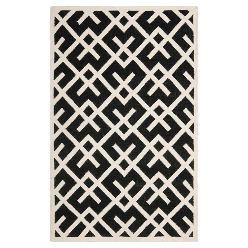 5'x8' Tangier Dhurry Rug Black/Ivory - Safavieh The Tangier Collection features contemporary flat weave rugs made using 100percent pure wool and faithful obedience to the traditions of local artisans of India. The original texture and soft colors of antique Tangier, so prized by collectors, is skillfully recreated in these sublime carpets. Classic geometric motifs, with their organic nuances in pattern and tone, are equally at home in casual, mod, and traditional settings. The results are natural, organic and with wonderful nuances in pattern and tone. Size: 5'X8'. Color: Black/Ivory. Pattern: Geometric Shapes.