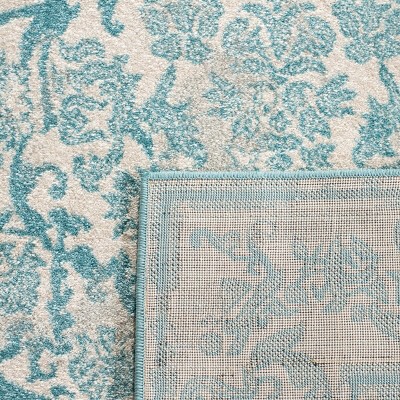 Ivory and Light Blue Synthetic Round Area Rug, 4' x 6'