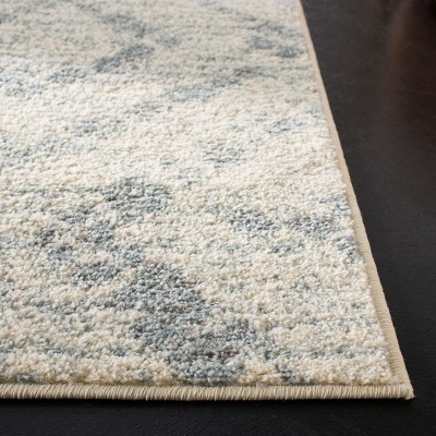 Ivory and Light Blue Geometric 8' x 10' Synthetic Area Rug