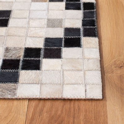 Handmade Black and Ivory Geometric Cowhide Area Rug