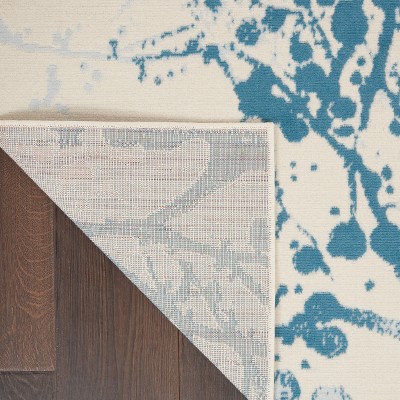 Ivory and Blue Abstract Synthetic 4' x 6' Easy-Care Area Rug