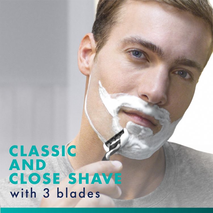 Person shaving with a black and white colored razor through white colored shaving cream on the lower face; text on the image reads "CLASSIC AND CLOSE SHAVE with 3 blades".