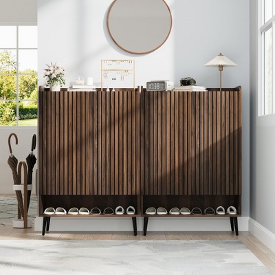 Two-tone wood shoe cabinet with vertical slats against wall