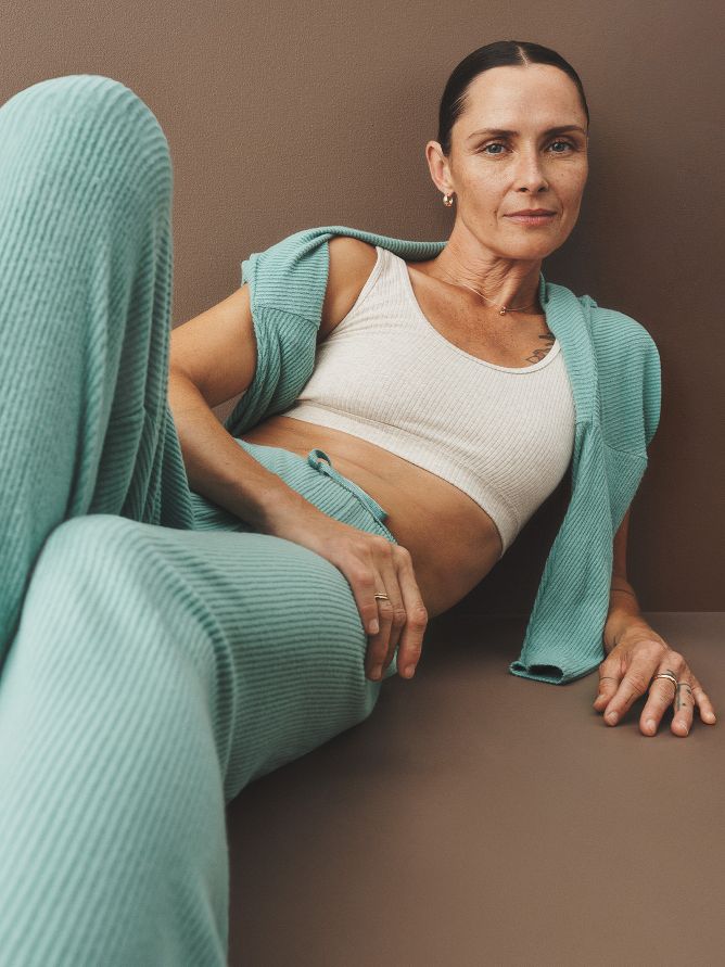 Aqua green ribbed pants are cozy as can be with a tie at the waist. Add a matching long-sleeve top, light bralette and hoop earrings to bring it all together.