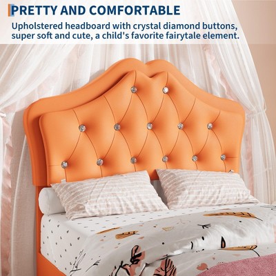 Close-up of tufted orange headboard with crystal button accents